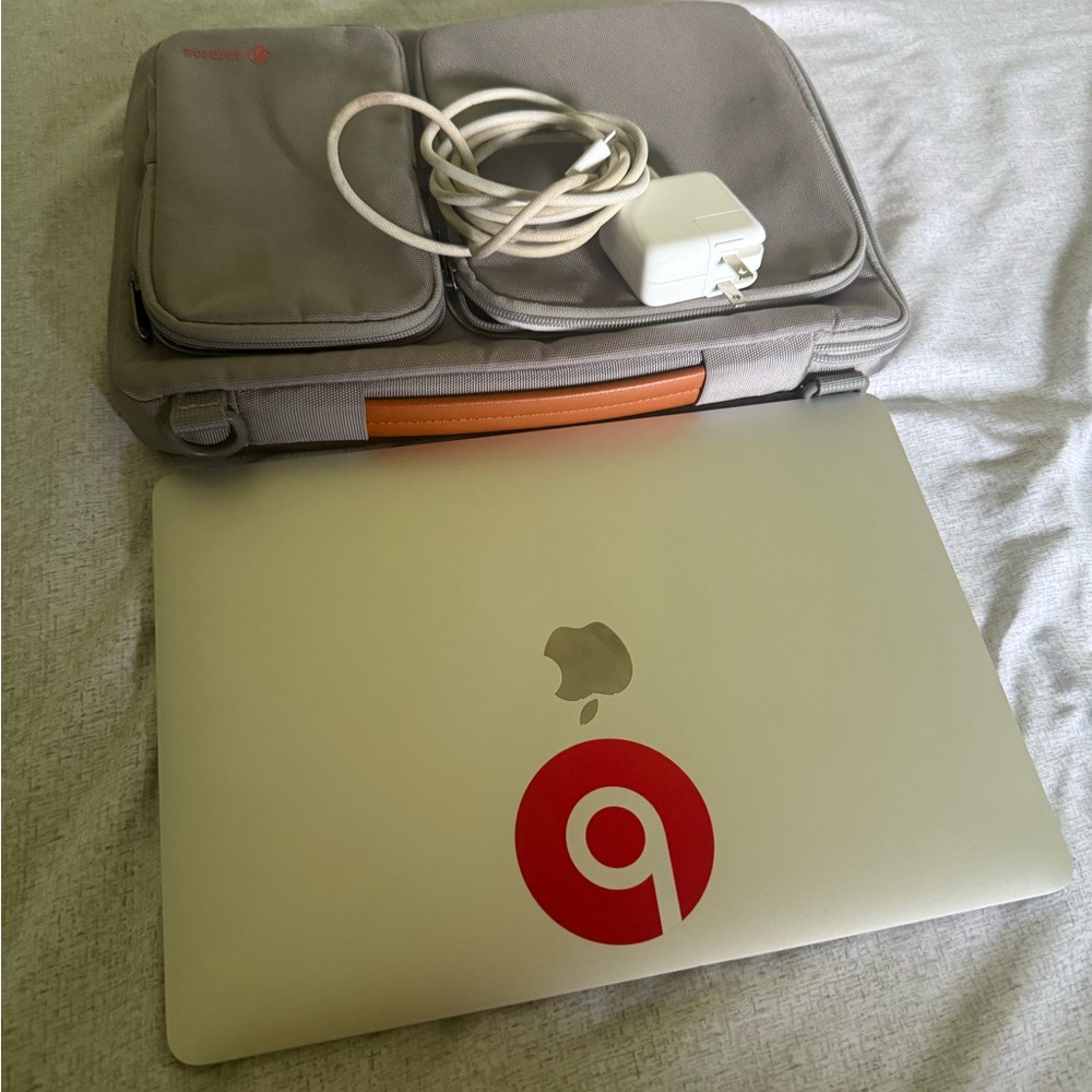 Apple Laptop with Red Logo and Silver Body